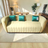 Curved Modern Sofa in Cream Upholstery with Teal Accent Pillows
