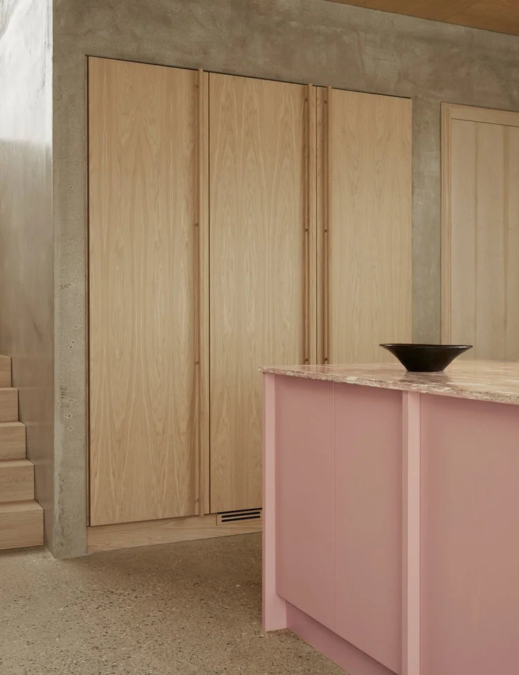 Light oak kitchen with pink kitchen island