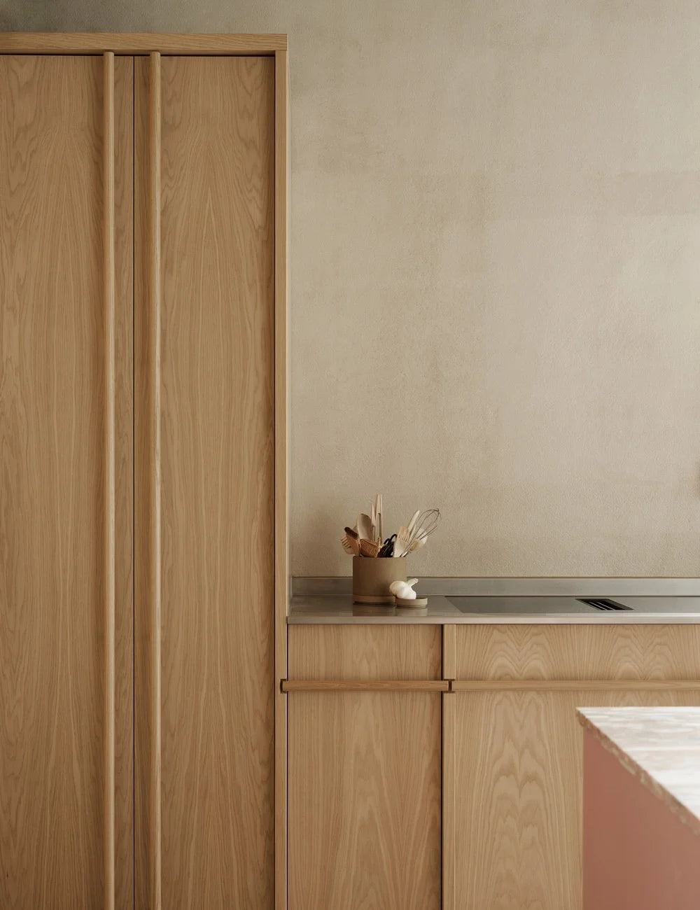 Light oak kitchen with pink kitchen island