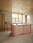 Light oak kitchen with pink kitchen island