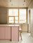 Light oak kitchen with pink kitchen island