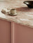 Light oak kitchen with pink kitchen island