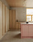 Light oak kitchen with pink kitchen island